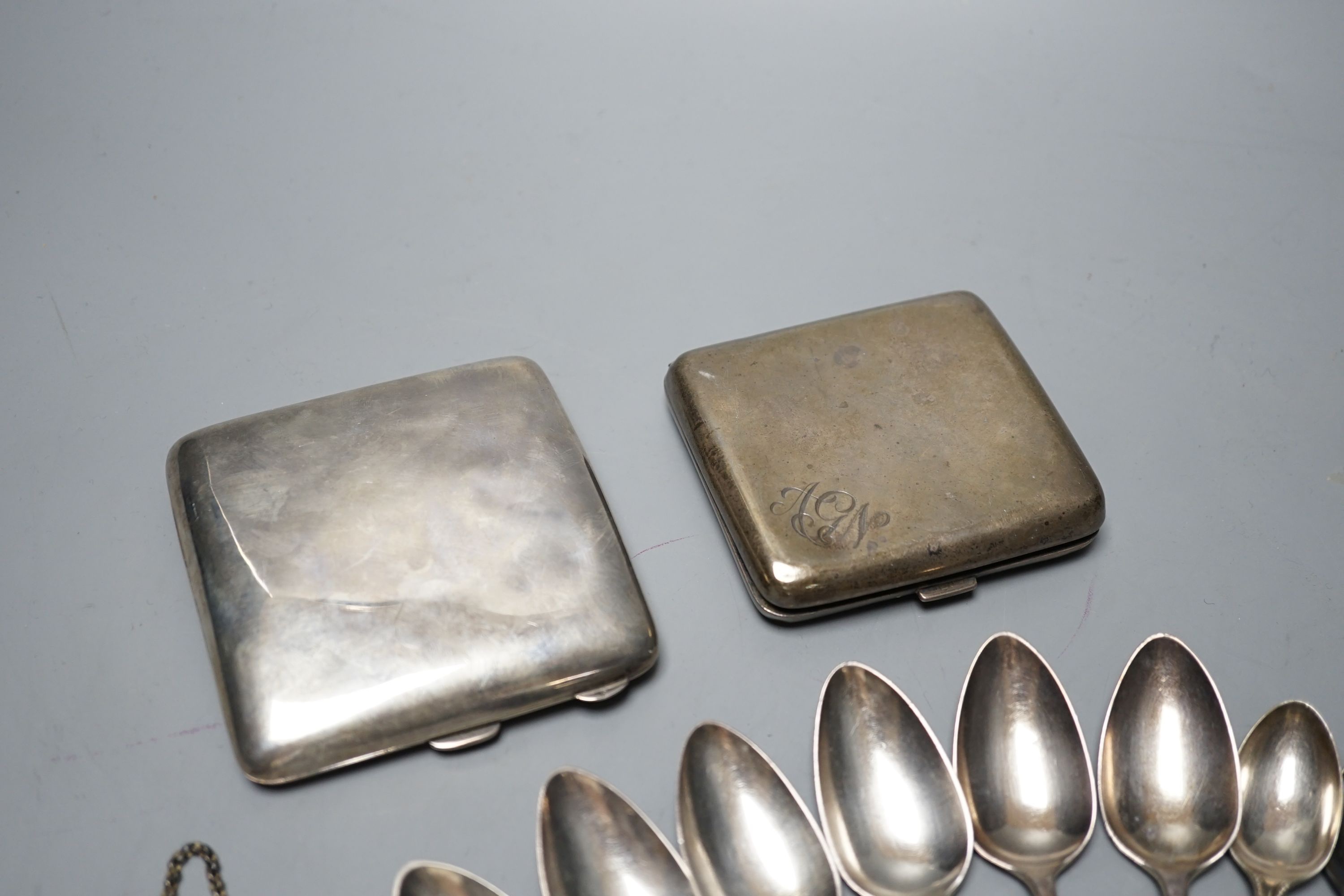 Two silver cigarette cases, a Georgian silver wine label and two sets of six silver teaspoons including London, 1801, 12.5oz.